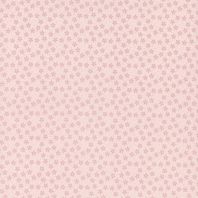 Light pink fabric with tiny tonal flowers crowded together amongst pinprick dots.