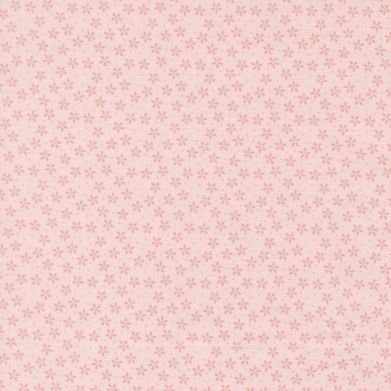 Light pink fabric with tiny tonal flowers crowded together amongst pinprick dots.