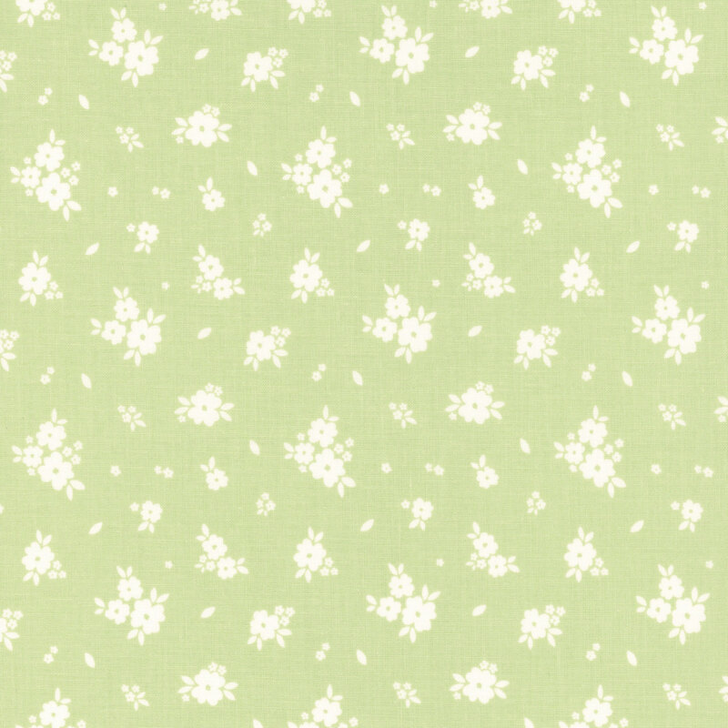 Green fabric with tossed clusters of white flowers.
