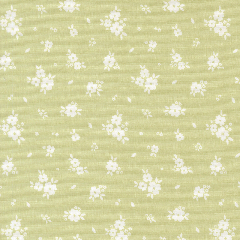 Green fabric with tossed clusters of white flowers.