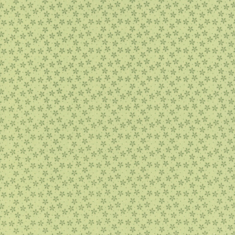 Green fabric with tiny tonal flowers crowded together amongst pinprick dots.