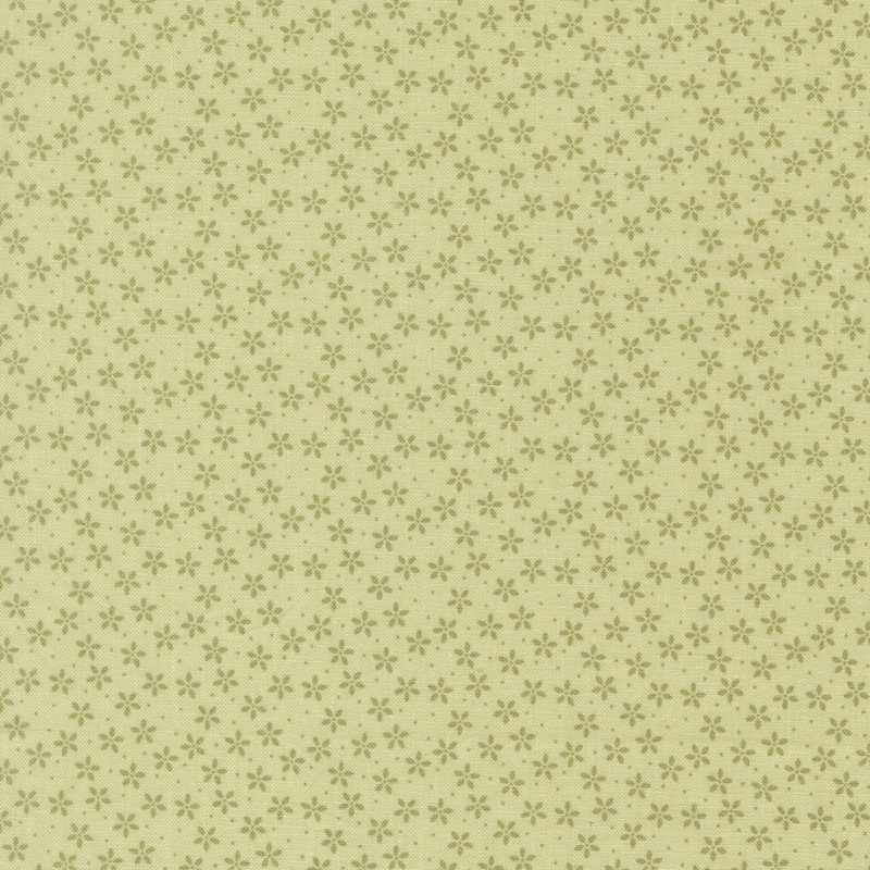 Green fabric with tiny tonal flowers crowded together amongst pinprick dots.