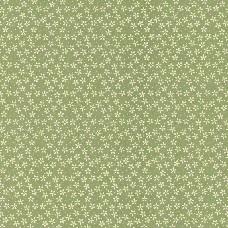 Grass green fabric with tiny white flowers crowded together amongst pinprick dots.
