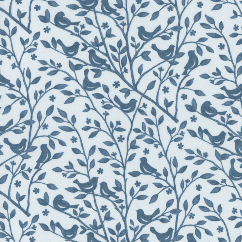 Vintage blue fabric swatch with a tonal dark blue pattern of leafy branches with birds perched atop them.