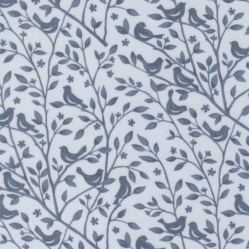Vintage blue fabric swatch with a tonal dark blue pattern of leafy branches with birds perched atop them.