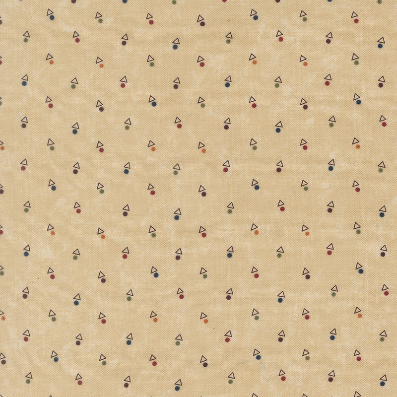 A mottled tan fabric with triangles and multicolored dots. 