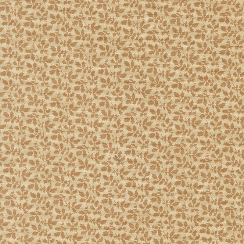 A mottled tan fabric with tonal leaf clusters. 