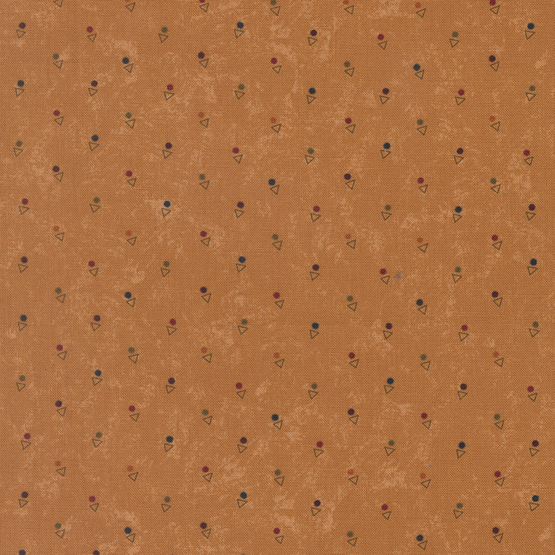 A mottled amber orange fabric with triangles and multicolored dots. 
