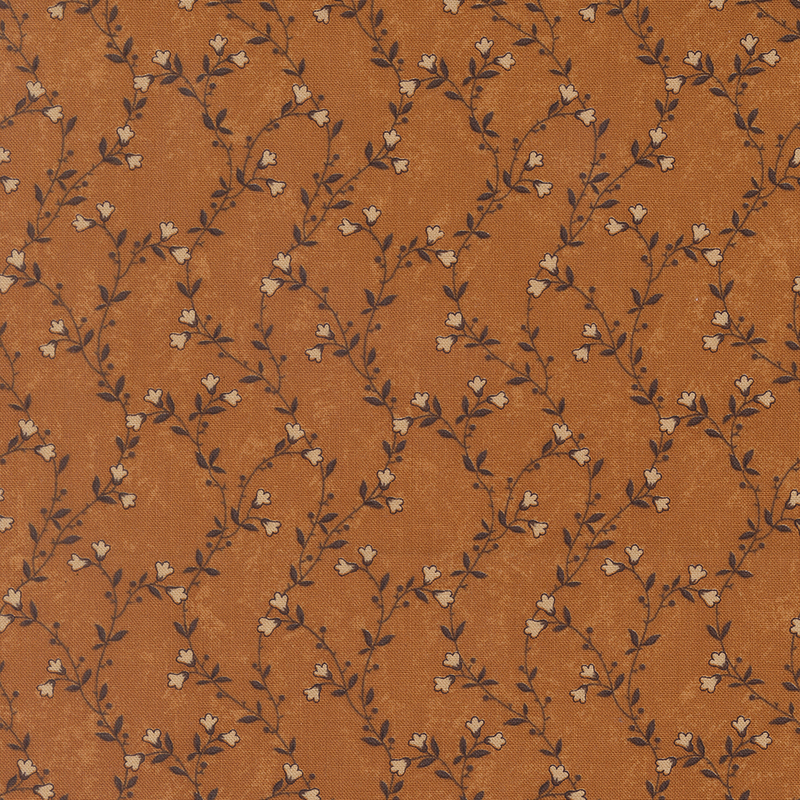 A mottled amber orange fabric featuring delicate green vines with cream flowers. 