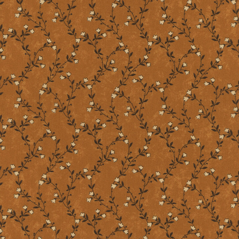 A mottled amber orange fabric featuring delicate green vines with cream flowers. 
