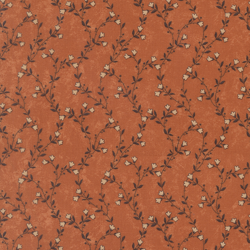 A mottled pumpkin orange fabric featuring delicate green vines with cream flowers. 