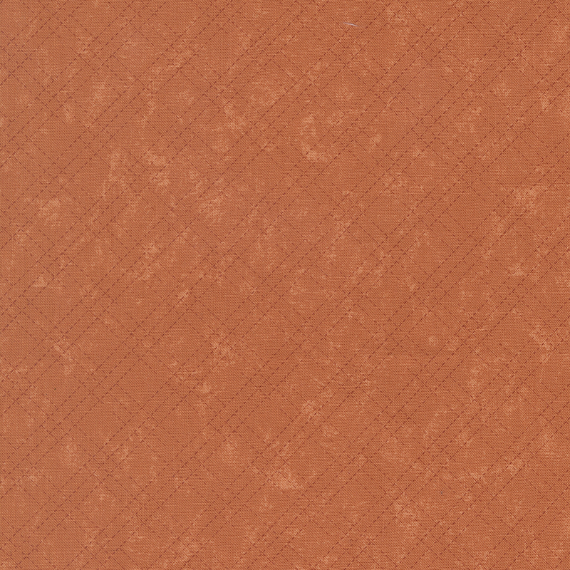 A mottled pumpkin orange fabric with a tonal stitched plaid design. 