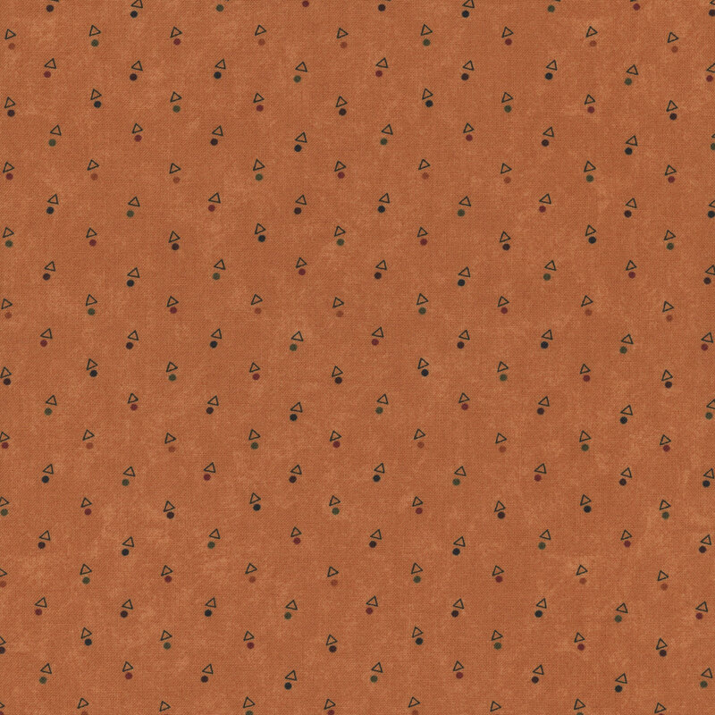 A mottled pumpkin orange fabric with triangles and multicolored dots. 