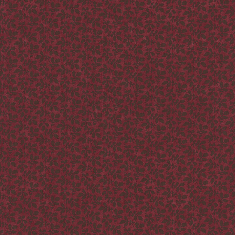 A mottled brick red fabric with tonal leaf clusters. 