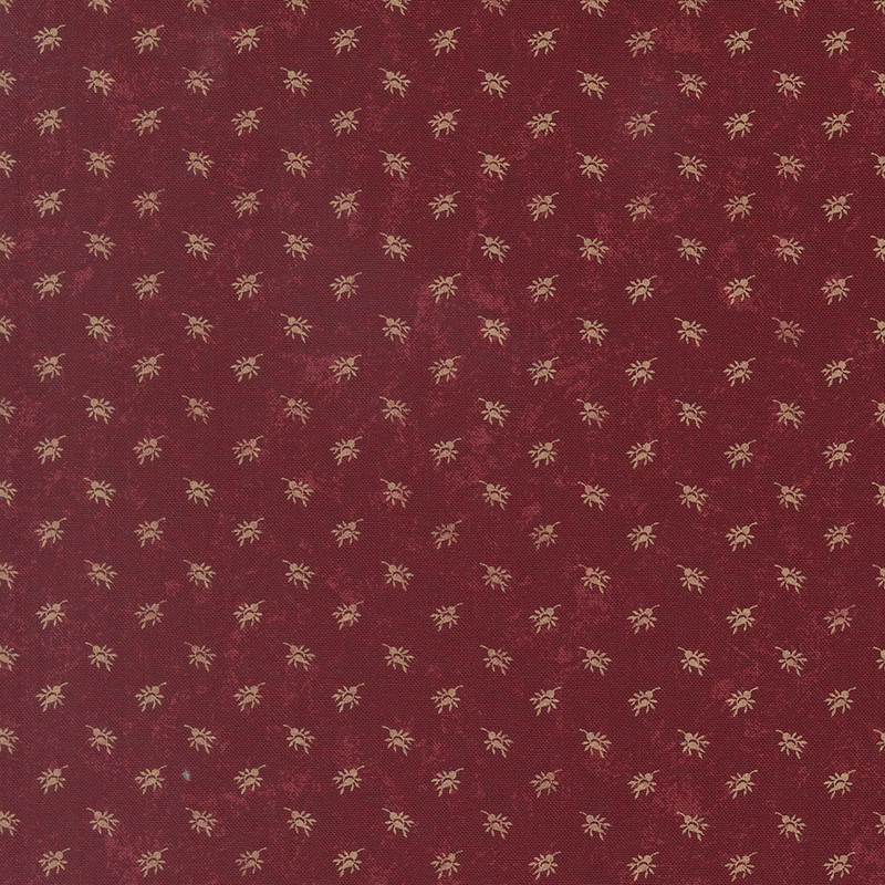 A mottled brick red fabric with cream rosebud sprays. 