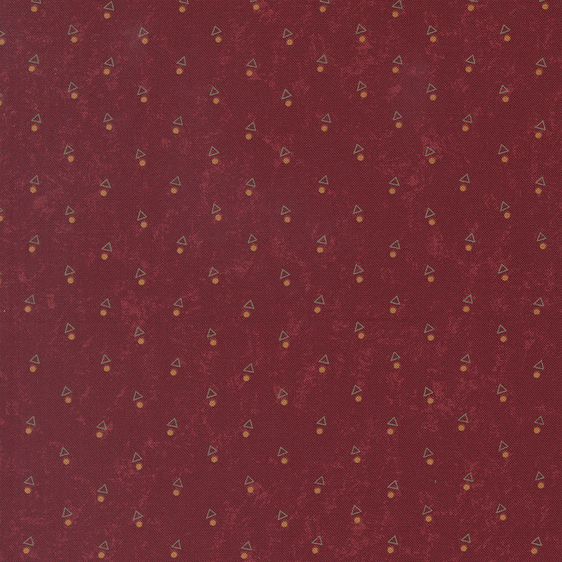 A mottled brick red fabric with triangles and orange dots. 