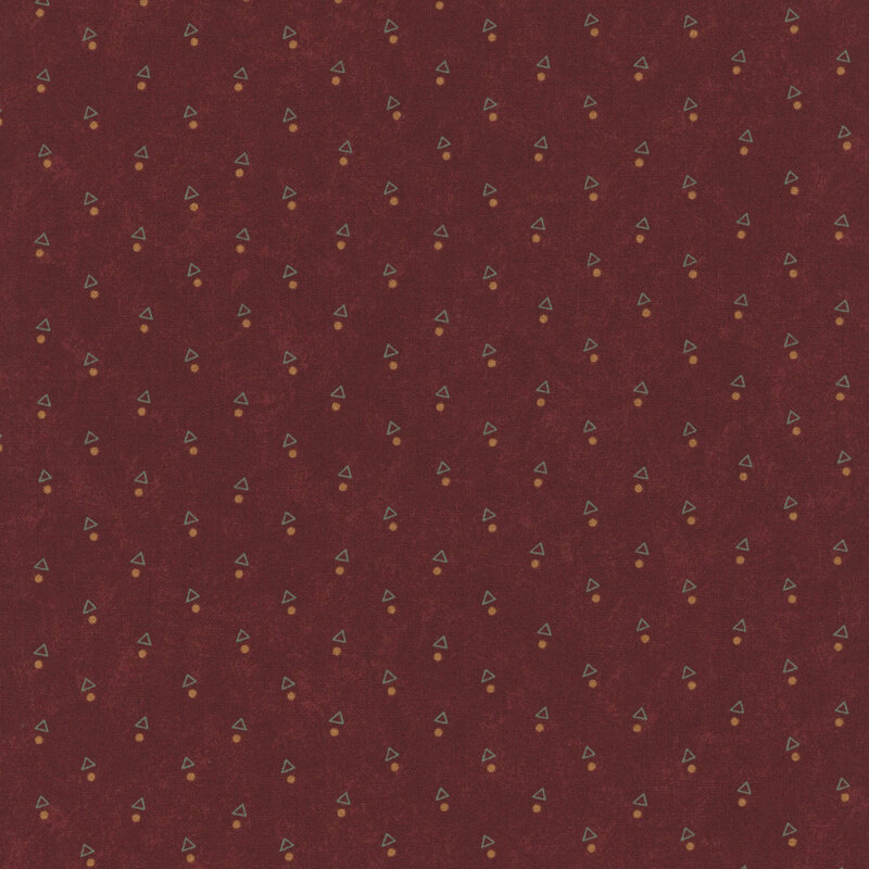 A mottled brick red fabric with triangles and orange dots. 