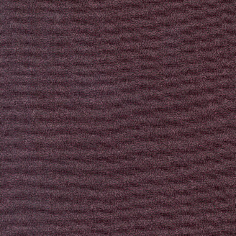 A mottled mulberry purple fabric with an arrangement of abstract tonal lines. 
