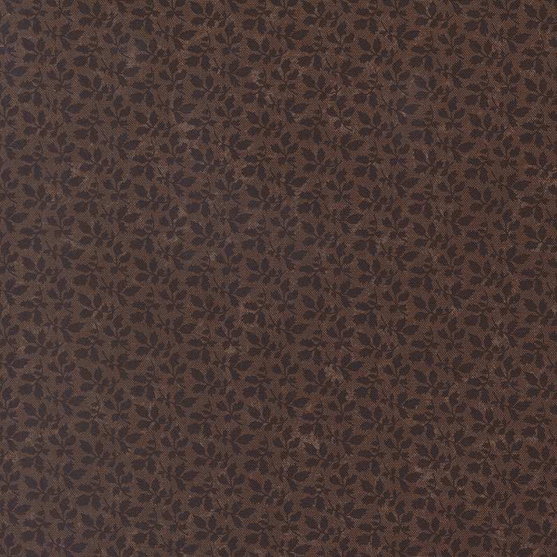 A mottled earthy brown fabric with tonal leaf clusters. 