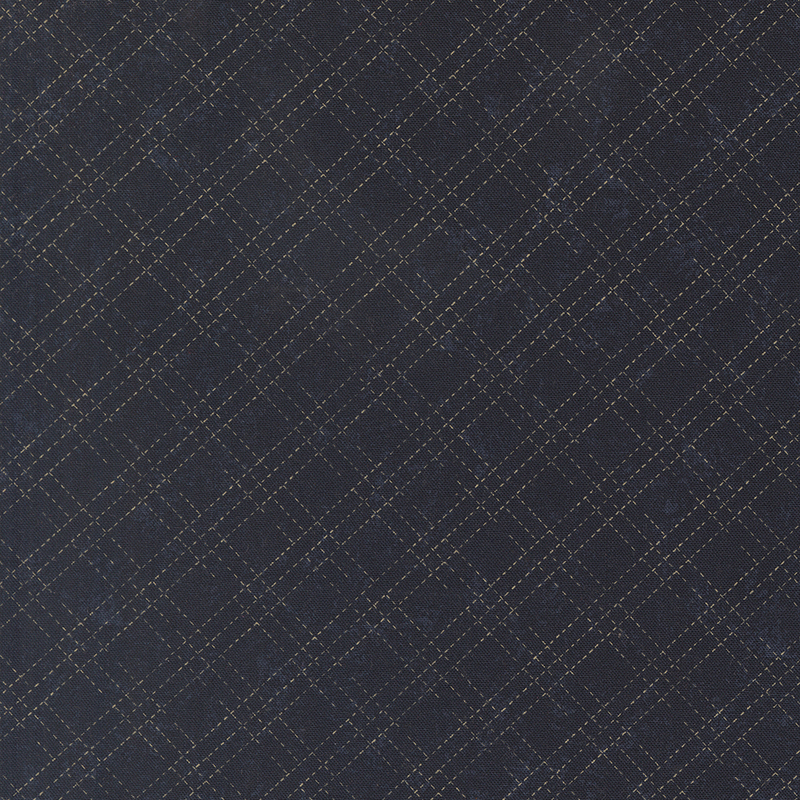 A mottled indigo blue fabric with a cream stitched plaid design. 