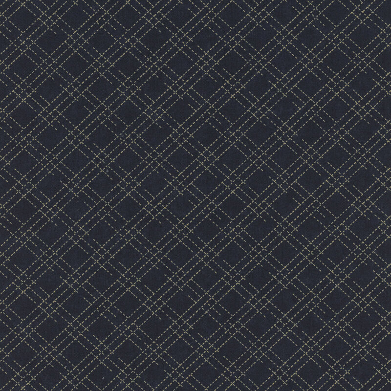 A mottled indigo blue fabric with a cream stitched plaid design. 