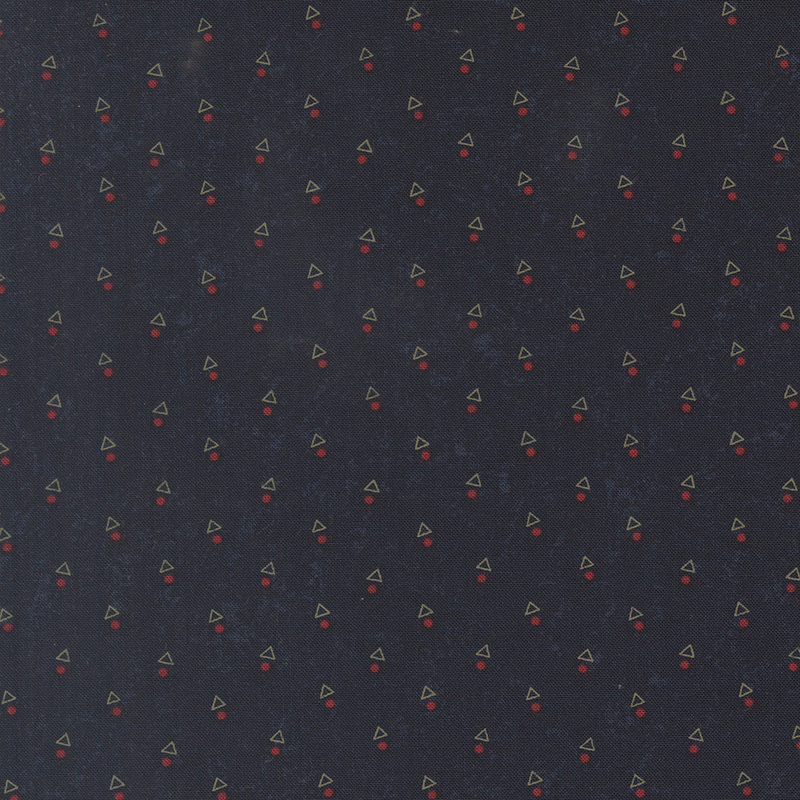 A mottled indigo blue fabric with triangles and red dots. 