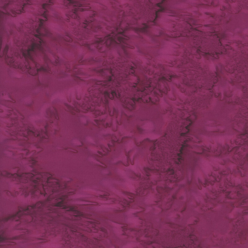 Fabric swatch of the 104 Cabernet Watercolor Batik, a mottled and tonal dark magenta print.