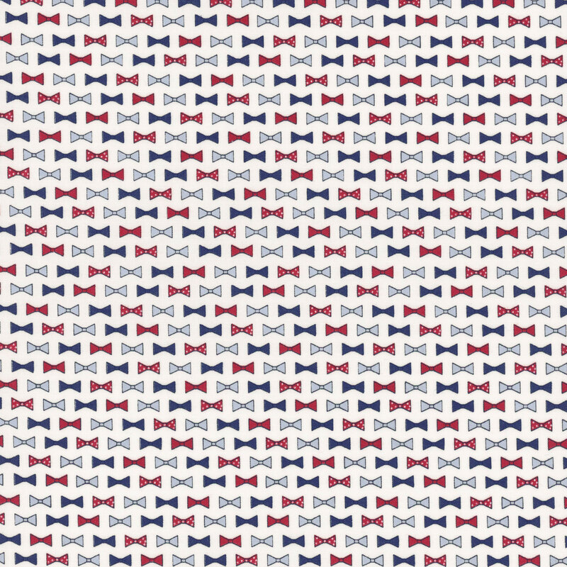 rows of bowties in red, cornflower blue, navy blue, and red with white polka dots on cloud white fabric
