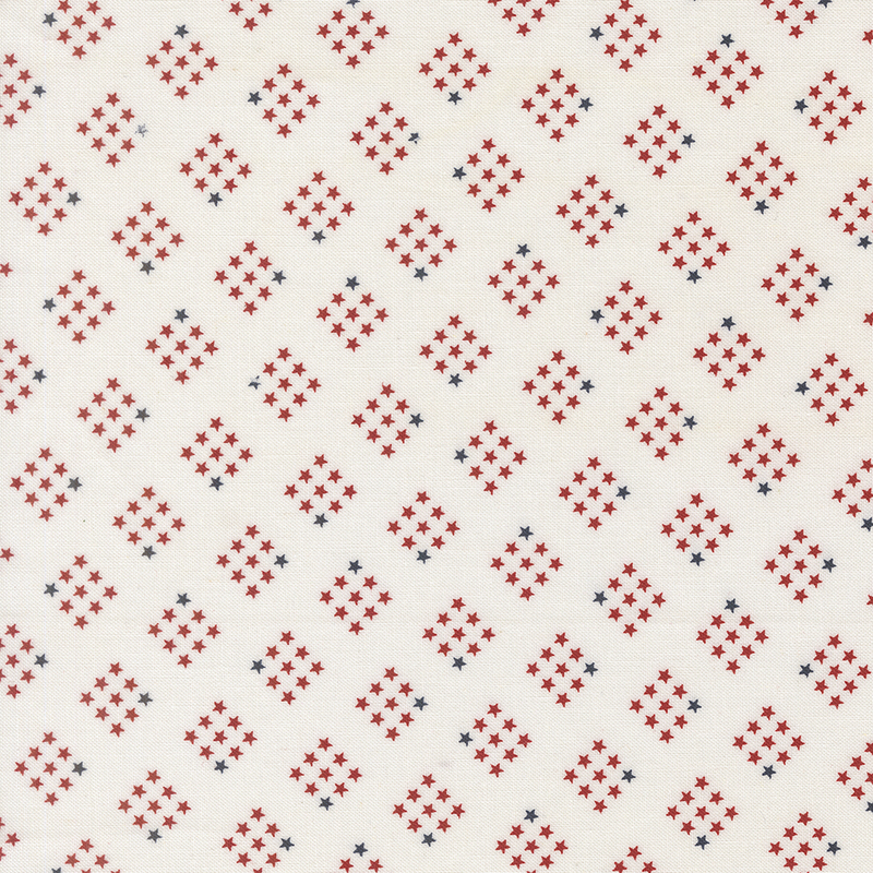 cloud white fabric featuring diamond-shaped clusters of red and navy stars