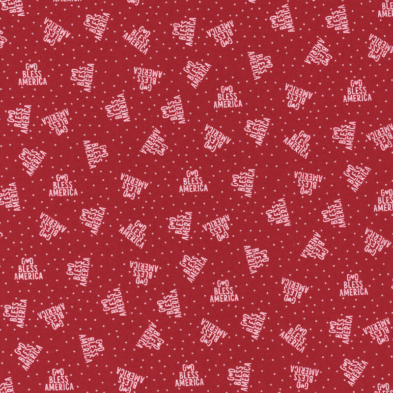bright red fabric featuring God Bless America in a triangle of white text on a background of white polka dots