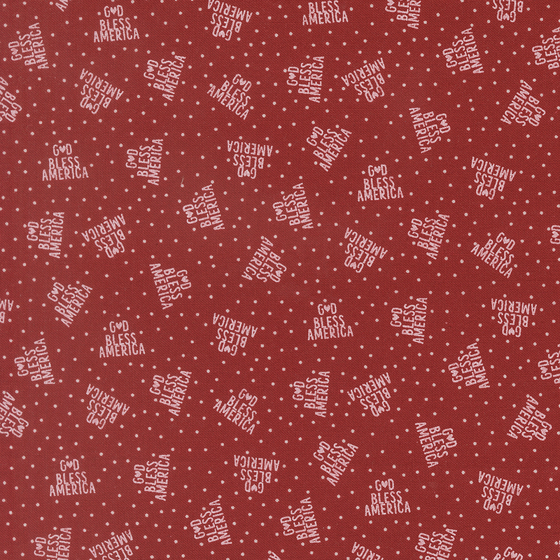 bright red fabric featuring God Bless America in a triangle of white text on a background of white polka dots
