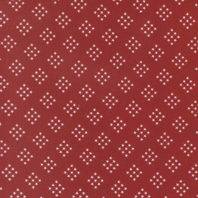 bright red fabric featuring diamond-shaped clusters of white stars