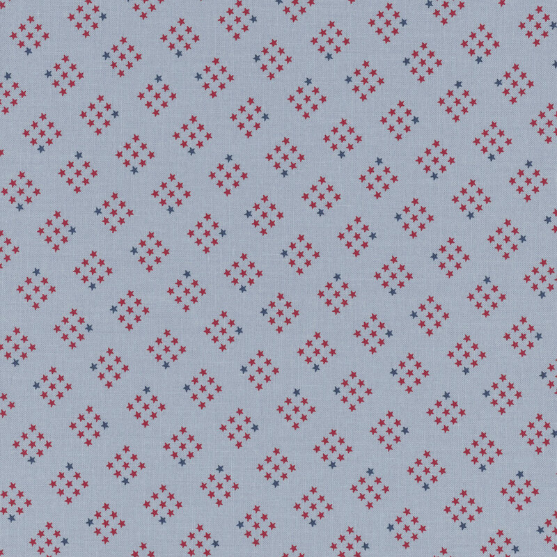 cornflower blue fabric featuring diamond-shaped clusters of red and navy stars