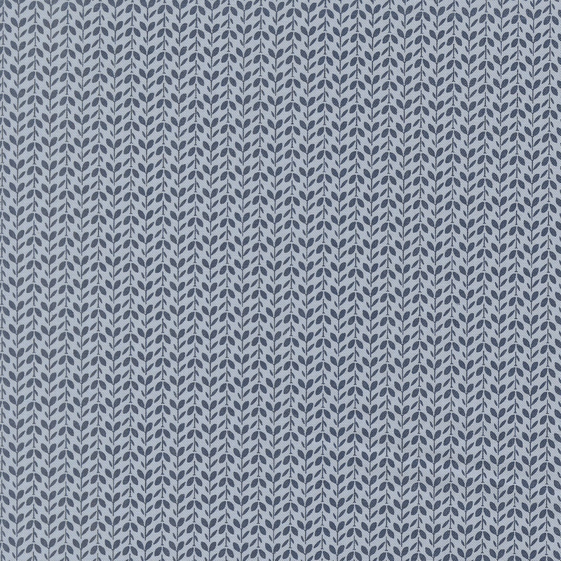 tonal blue fabric packed with vines and leaves in alternating directions