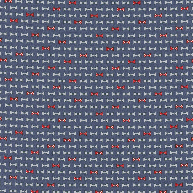 diagonal rows of bowties in cornflower blue and red with white polka dots on navy blue fabric