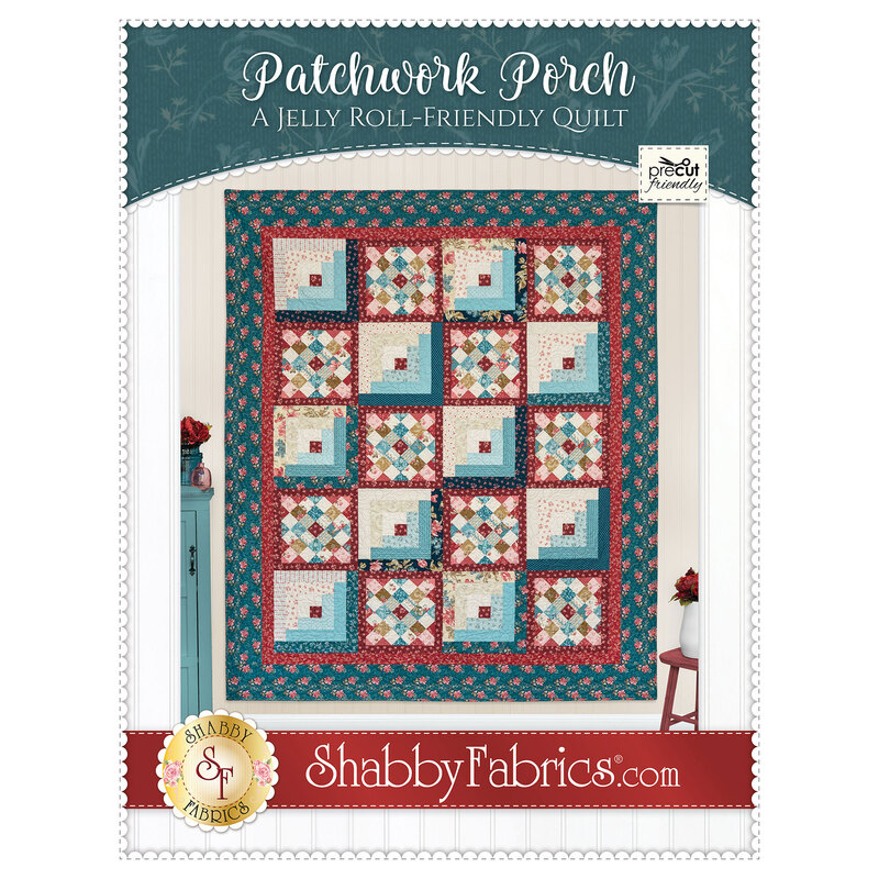Front cover of the pattern featuring the completed quilt in ocean blue, brick red, and sandy cream, staged on a cream wall with coordinating decor.