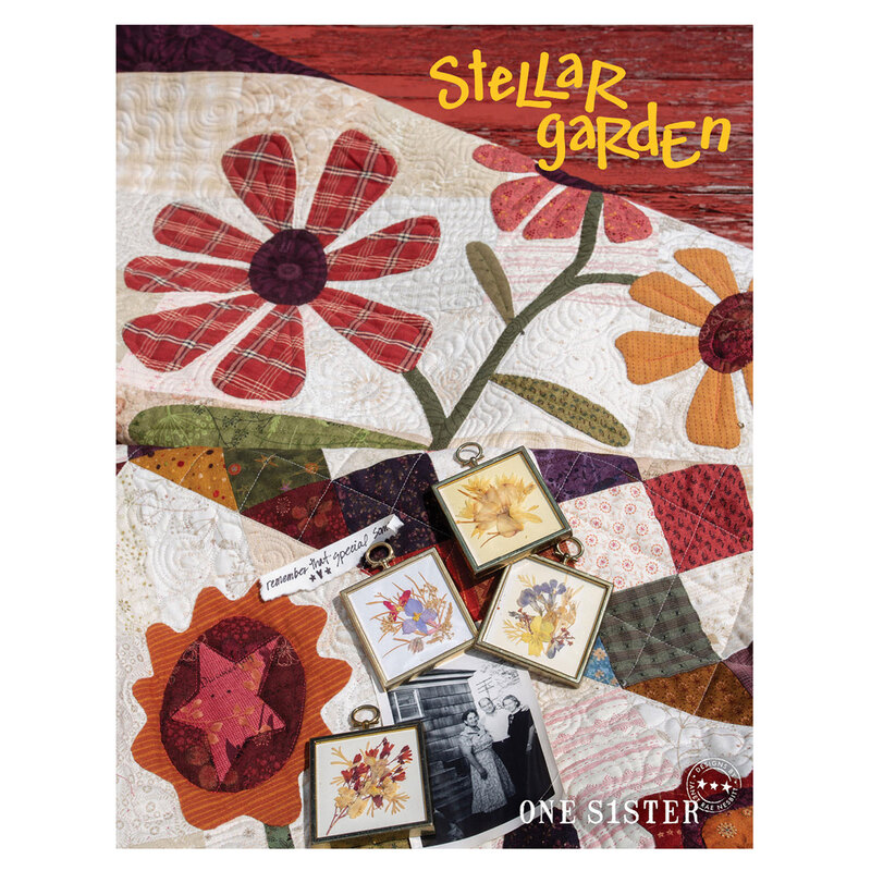 Cover of a quilt pattern book titled Stellar Garden featuring large appliqué flowers, fall colored quilt squares, old family photos, and dried flowers in antique frames. Designed by Janet Nesbit for One Sister. 