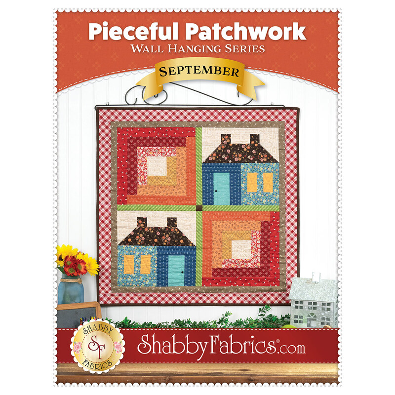 Front cover showing the completed project's vibrantly colored log cabin and schoolhouse blocks.