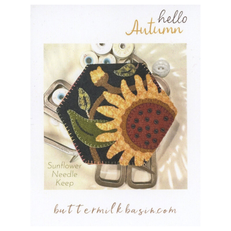 Front cover of the pattern showing the completed project sewing bobbins and tools.