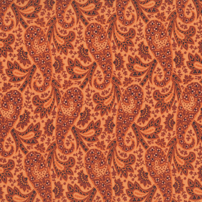 Orange fabric with a floral paisley pattern accented with stylized leaves.