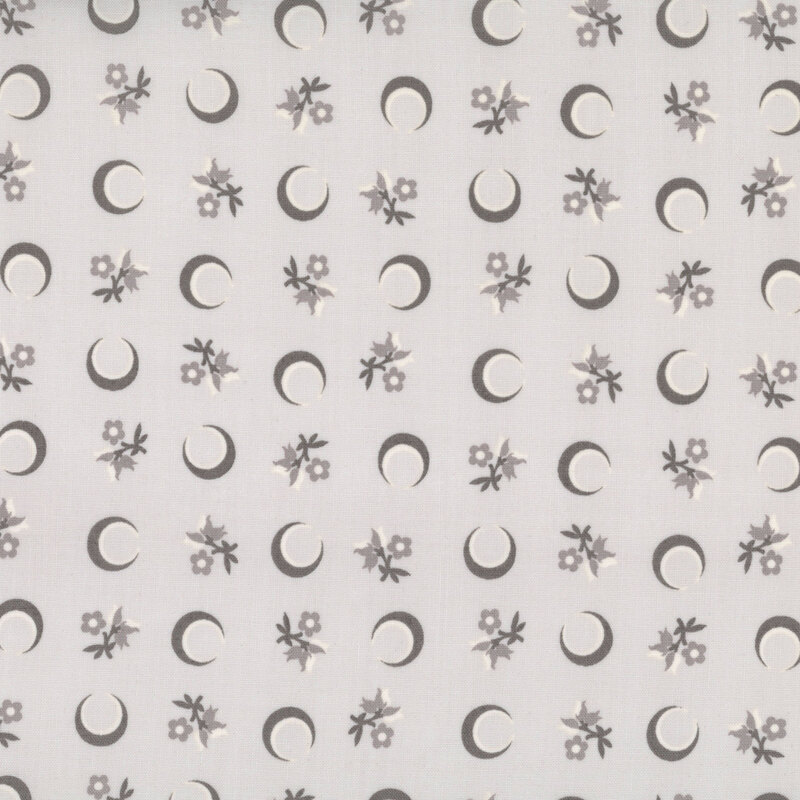 Gray fabric with a tossed pattern of crescent moons and florals.