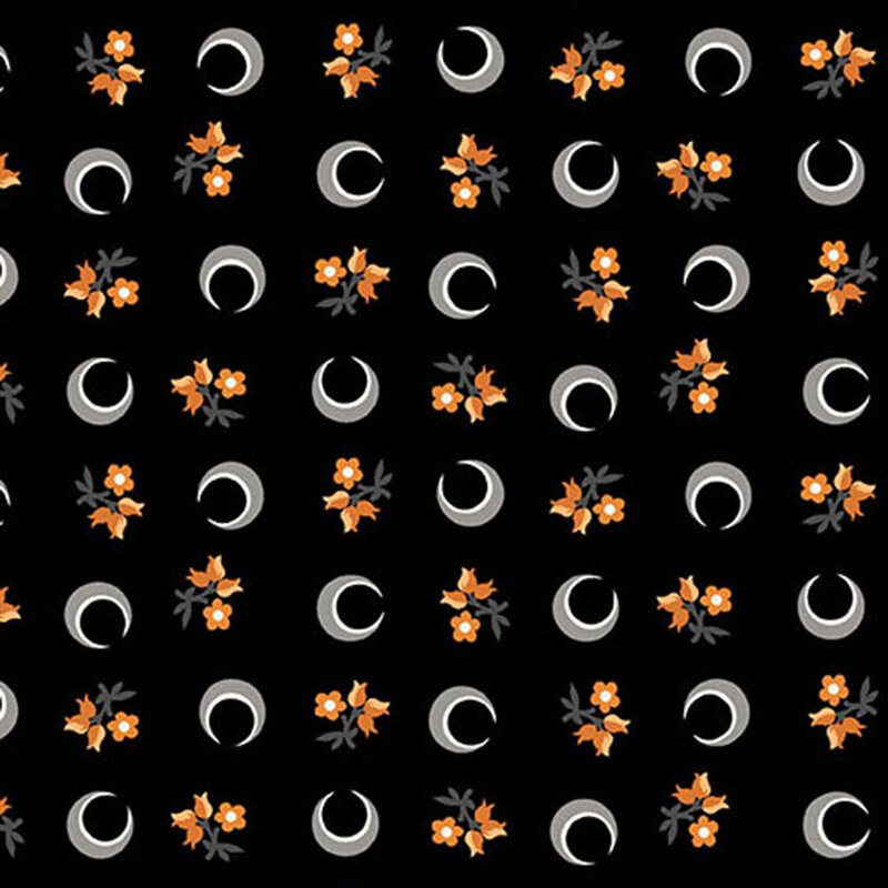 Black fabric with a ditsy pattern of crescent moons and florals.