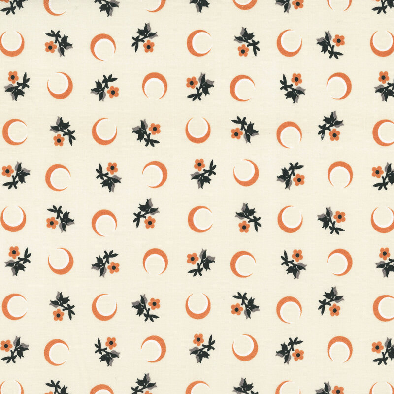 Cream fabric with a tossed pattern of crescent moons and florals.