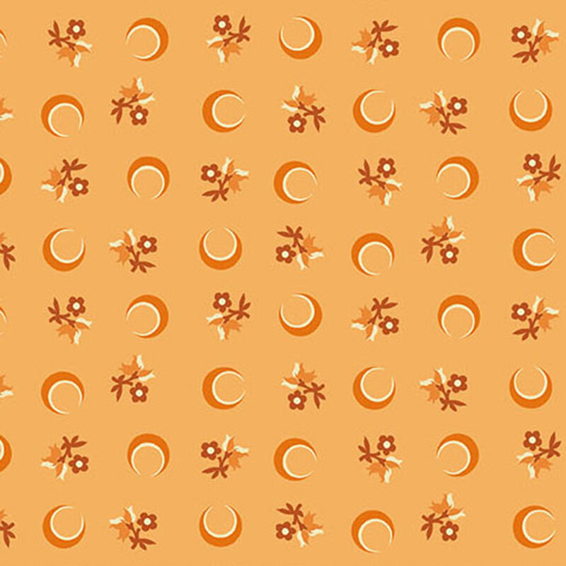 Orange fabric with a ditsy pattern of crescent moons and florals.
