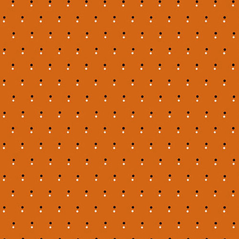 Orange fabric with a pattern of evenly spaced dots in black and white.