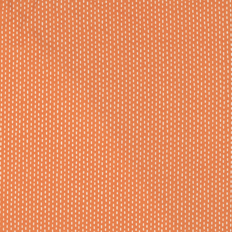 Orange fabric with white stripes formed by a stitch pattern.