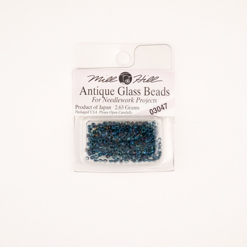 A package of Mill Hill Antique Seed Beads in the color blue iris. 