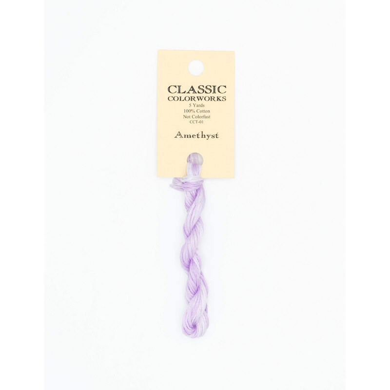 A skein of light purple embroidery floss, twisted and bundled, with a cream and black label featuring the brand name and color information.