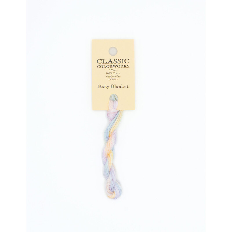 A skein of variegated peach, light purple, light blue, and yellow embroidery floss, twisted and bundled, with a cream and black label featuring the brand name and color information.