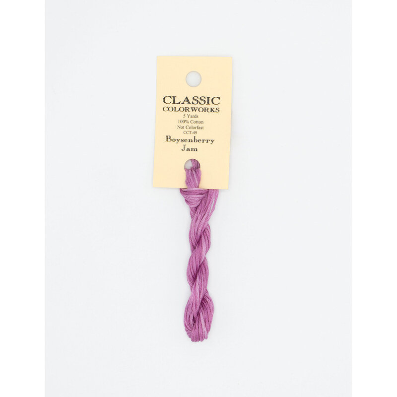 A skein of orchid pink embroidery floss, twisted and bundled, with a cream and black label featuring the brand name and color information.